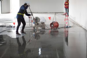 Construction,worker,painting,epoxy,flooring,or,floor,hardener